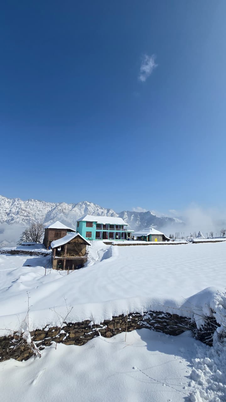 Sunset colours over the Dwat Mahadev ridgeline with village lights beginning to glow, Chamba