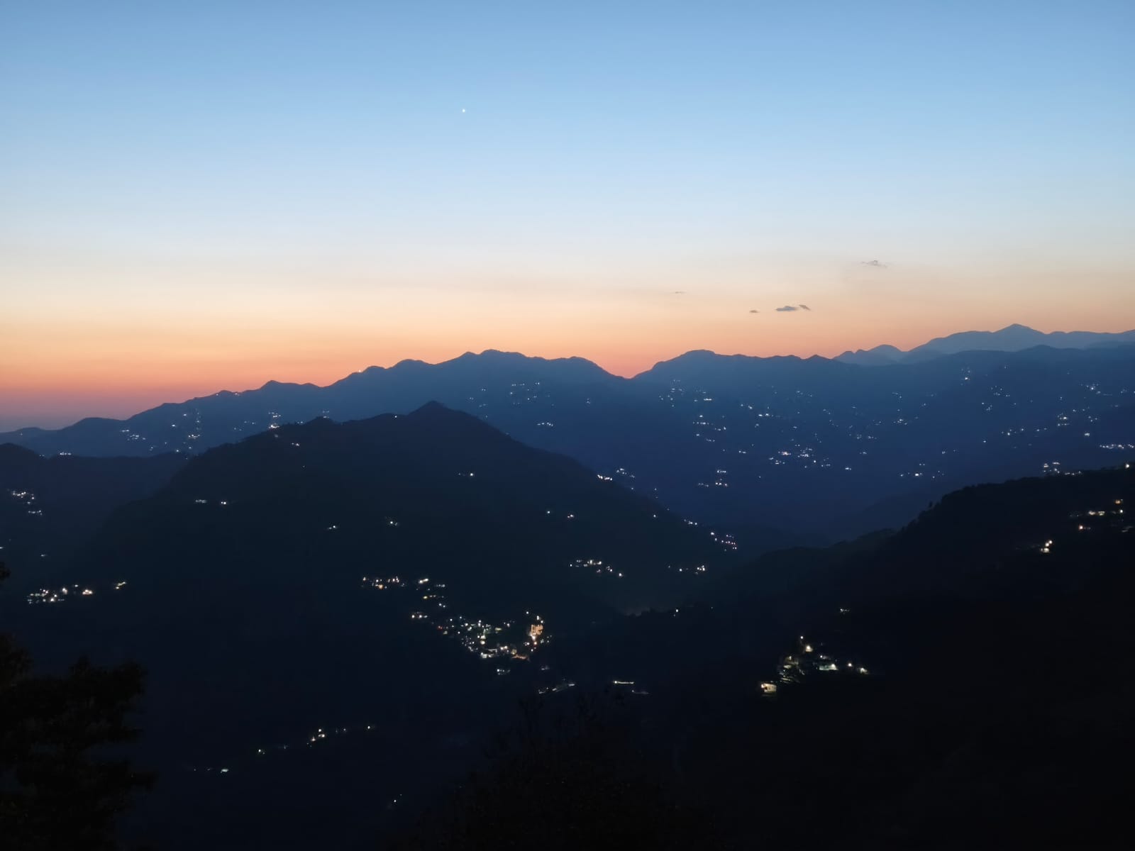 Twilight over Dwat Mahadev Valley with village lights below — sunset from Borkha hamlet