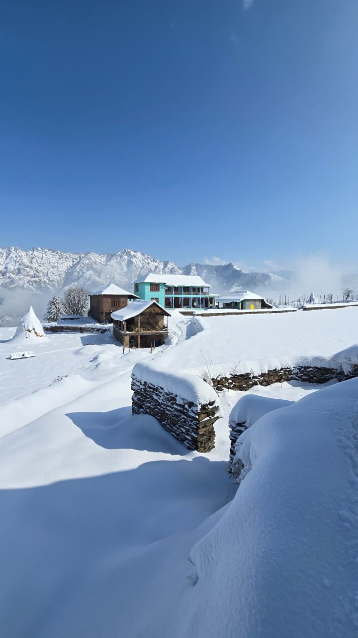 Gaddi family courtyard with traditional mountain architecture — Dwat Mahadev Valley homestay, Chamba