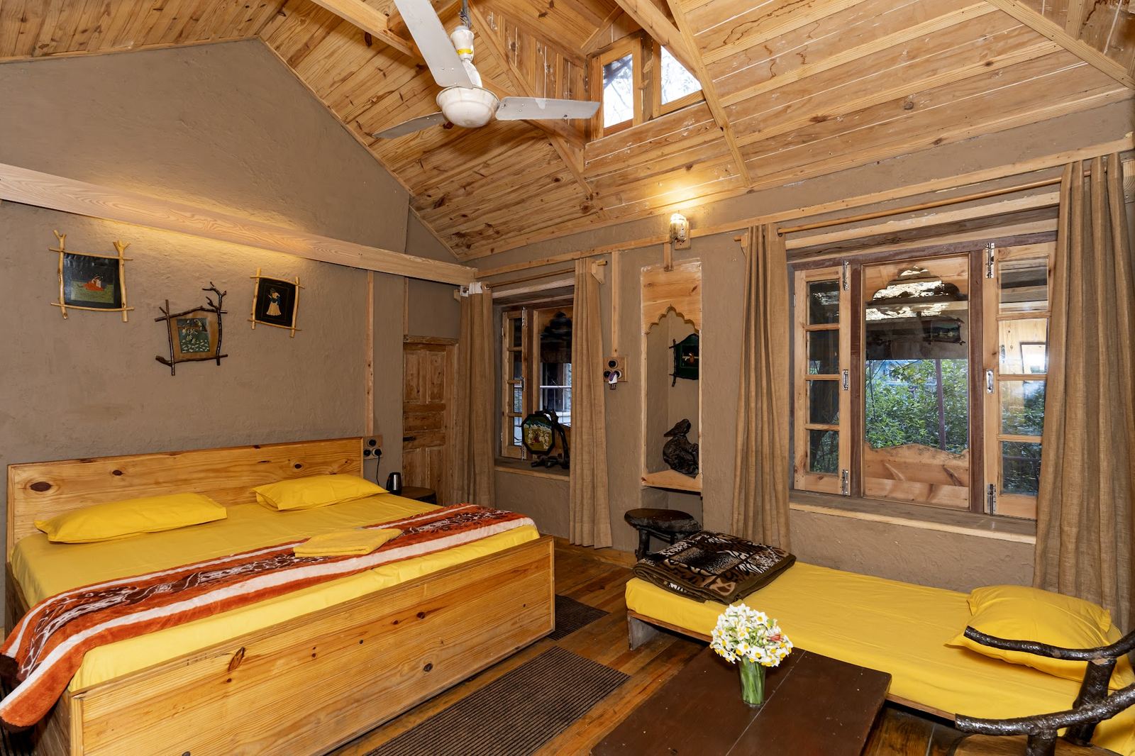 Interior of a riverside double room at Parbatwaas Retreat with walnut wood and mountain view